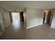 Open-concept living area with neutral tile floors, perfect for modern living and easy maintenance at 9411 Rainbow Ln, Port Richey, FL 34668
