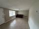 Bright living room with tile flooring, a large window, and a comfortable sofa for relaxation and entertainment at 9411 Rainbow Ln, Port Richey, FL 34668