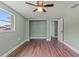 Light-filled bedroom with wood floors, an open closet, and a bright window at 10039 Old Hickory Ln, Port Richey, FL 34668