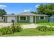 Charming single-story home featuring a freshly painted exterior and meticulously maintained landscaping at 10039 Old Hickory Ln, Port Richey, FL 34668