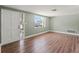 Spacious living room features a window for natural light, new floors, and a freshly painted interior at 10039 Old Hickory Ln, Port Richey, FL 34668