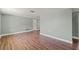 Open living room featuring wood floors, neutral paint, and a comfortable space at 10039 Old Hickory Ln, Port Richey, FL 34668