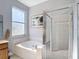 Bright bathroom featuring a soaking tub and walk-in glass shower at 10323 Birdwatch Dr, Tampa, FL 33647