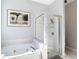 The bright bathroom features a walk-in shower and soaking tub at 10323 Birdwatch Dr, Tampa, FL 33647