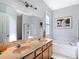 Bright bathroom featuring a double vanity, soaking tub, and glass shower at 10323 Birdwatch Dr, Tampa, FL 33647