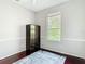 Bedroom has hardwood floors, an area rug, and a bright window at 10323 Birdwatch Dr, Tampa, FL 33647