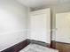 A cozy bedroom features hardwood floors, closet and neutral paint at 10323 Birdwatch Dr, Tampa, FL 33647