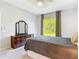 Comfortable carpeted bedroom features backyard views and neutral decor at 10323 Birdwatch Dr, Tampa, FL 33647