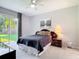 Comfortable bedroom with backyard access featuring neutral decor and carpet at 10323 Birdwatch Dr, Tampa, FL 33647
