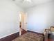 The bedroom has a ceiling fan, hardwood floors, and an open door at 10323 Birdwatch Dr, Tampa, FL 33647