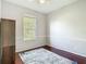Bedroom with hardwood floors, area rug, large window, and a ceiling fan at 10323 Birdwatch Dr, Tampa, FL 33647