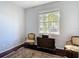 Bedroom with hardwood floors, area rug, large window, and chair rail at 10323 Birdwatch Dr, Tampa, FL 33647