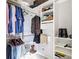 Walk-in closet features hanging racks, shelving, and storage space at 10323 Birdwatch Dr, Tampa, FL 33647