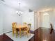 Cozy dining area featuring hardwood floors, a chandelier, and natural light at 10323 Birdwatch Dr, Tampa, FL 33647