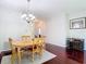 Cozy dining area with wood floors, a light-filled chandelier, and a decorative rug at 10323 Birdwatch Dr, Tampa, FL 33647