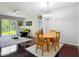 Open-concept dining area with hardwood floors and seamless flow to the living space at 10323 Birdwatch Dr, Tampa, FL 33647