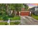 Charming single-Gathering home with a well-manicured front lawn and a two-car garage at 10323 Birdwatch Dr, Tampa, FL 33647