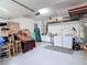 Spacious garage with laundry area, ample storage, and work space, ideal for projects and organization at 10323 Birdwatch Dr, Tampa, FL 33647