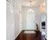 Bright entryway featuring hardwood floors, neutral walls, and decorative lighting fixtures at 10323 Birdwatch Dr, Tampa, FL 33647