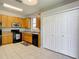 An eat-in kitchen features oak cabinets, tile flooring and white bi-fold closet doors at 10323 Birdwatch Dr, Tampa, FL 33647