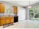 Bright kitchen with natural wood cabinets and a sliding glass door to the outside at 10323 Birdwatch Dr, Tampa, FL 33647