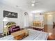 Open living area with a sliding glass door, ceiling fan, and view to the front entry at 10323 Birdwatch Dr, Tampa, FL 33647