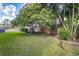 Lush backyard featuring manicured landscaping, a wooden fence, and mature trees at 10364 Lightner Bridge Dr, Tampa, FL 33626