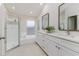Bright bathroom showcasing a glass shower, soaking tub, double vanity, and ample natural light at 10364 Lightner Bridge Dr, Tampa, FL 33626