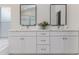 Elegant bathroom featuring a double vanity with marble countertops and ample storage at 10364 Lightner Bridge Dr, Tampa, FL 33626