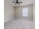 Bright bedroom with neutral carpet, ceiling fan, and a window with blinds at 10364 Lightner Bridge Dr, Tampa, FL 33626