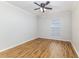 Spacious bedroom features wood floors, a ceiling fan, and natural light from a window at 10364 Lightner Bridge Dr, Tampa, FL 33626
