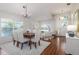 Open-concept living and dining area showcasing wood floors, modern furnishings, and ample natural light at 10364 Lightner Bridge Dr, Tampa, FL 33626