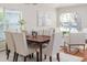 Bright dining room featuring a modern chandelier, a large window, and wood floors at 10364 Lightner Bridge Dr, Tampa, FL 33626