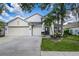 Charming single-Gathering home with a three-car garage and well-manicured landscaping, including mature palm trees at 10364 Lightner Bridge Dr, Tampa, FL 33626