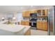 Well-equipped kitchen with stainless steel appliances, glass front cabinets, and ample countertop space at 10364 Lightner Bridge Dr, Tampa, FL 33626