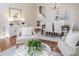 Cozy living room with elegant furnishings, wood floors, and seamless transition to the dining area at 10364 Lightner Bridge Dr, Tampa, FL 33626