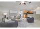 Cozy living room featuring a ceiling fan, stylish furniture, and seamless access to the kitchen at 10364 Lightner Bridge Dr, Tampa, FL 33626