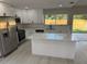 Bright kitchen with stainless steel appliances, quartz countertops, and white cabinets at 10999 Del Prado E Dr, Largo, FL 33774