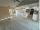 Open-concept living space with updated flooring, modern kitchen, and lots of natural light at 10999 Del Prado E Dr, Largo, FL 33774