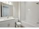 Bathroom featuring a single sink vanity, shower and tub combination, and bright lighting at 11622 Gleaming Ter, Venice, FL 34293