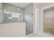 Modern bathroom featuring a glass shower enclosure, rain shower head, and a light-filled window at 11622 Gleaming Ter, Venice, FL 34293