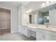 Bathroom featuring double sinks, white cabinets, and a glass shower at 11622 Gleaming Ter, Venice, FL 34293