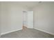 Carpeted bedroom featuring neutral color palette, adjacent to closet with white trim and single door at 11622 Gleaming Ter, Venice, FL 34293