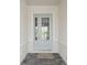 Inviting front entrance showcasing a light blue door with glass panels and stone tile walkway at 11622 Gleaming Ter, Venice, FL 34293