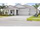 Beautiful single-Gathering home with a three-car garage, large driveway, and well-manicured lawn at 11622 Gleaming Ter, Venice, FL 34293