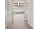 Hallway view leading to a bright living area with beamed ceilings and sliding glass doors to the pool at 11622 Gleaming Ter, Venice, FL 34293