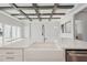 Kitchen island showcasing stainless steel sink, white cabinets and a decorative beamed ceiling at 11622 Gleaming Ter, Venice, FL 34293