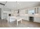 Expansive white kitchen featuring modern appliances, an island, and ample cabinet space at 11622 Gleaming Ter, Venice, FL 34293
