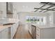 Modern kitchen with stainless appliances, bright white cabinetry, and an island with seating at 11622 Gleaming Ter, Venice, FL 34293