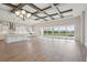 Bright open living area featuring wood-look floors, decorative ceilings and sliding glass doors to the outdoor pool at 11622 Gleaming Ter, Venice, FL 34293